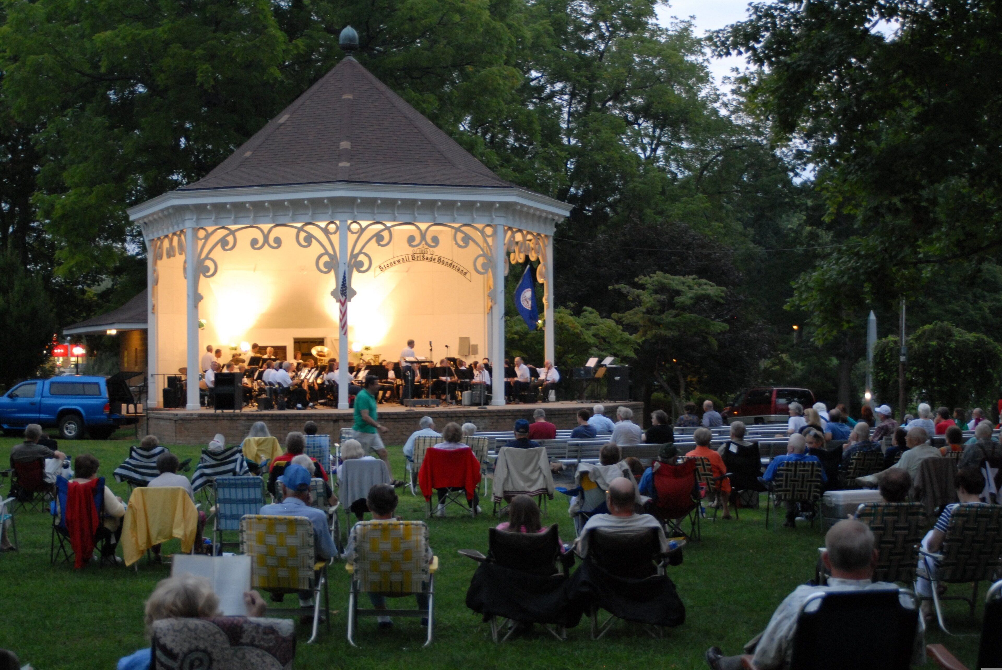 A gazebo with a band performing, surrounded by seated guests.