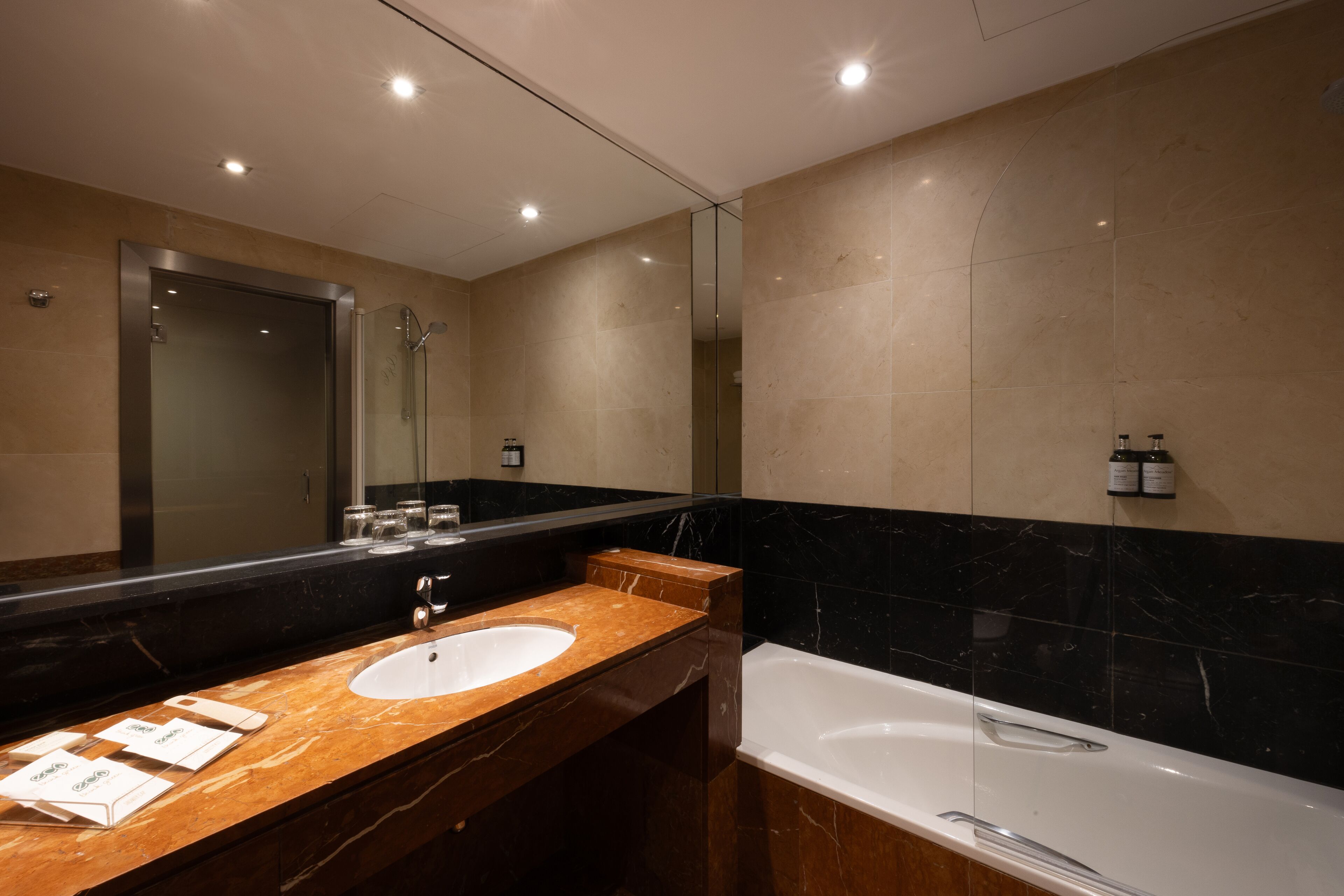 bathtub, eco-friendly toiletries, hair dryer, towels