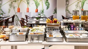 A buffet with various food items and a wall mural with plants. - Catalonia Diagonal Centro (Barcelona)