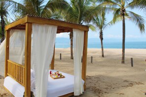 A wooden beach cabana with a bed and a tray of fruit and drinks. - Fiesta Americana Puerto Vallarta All Inclusive & Spa (Puerto Vallarta)