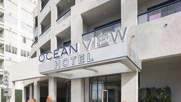 Stunning Ocean View Hotel entrance, accessible via stairs, surrounded by a beautifully maintained garden.