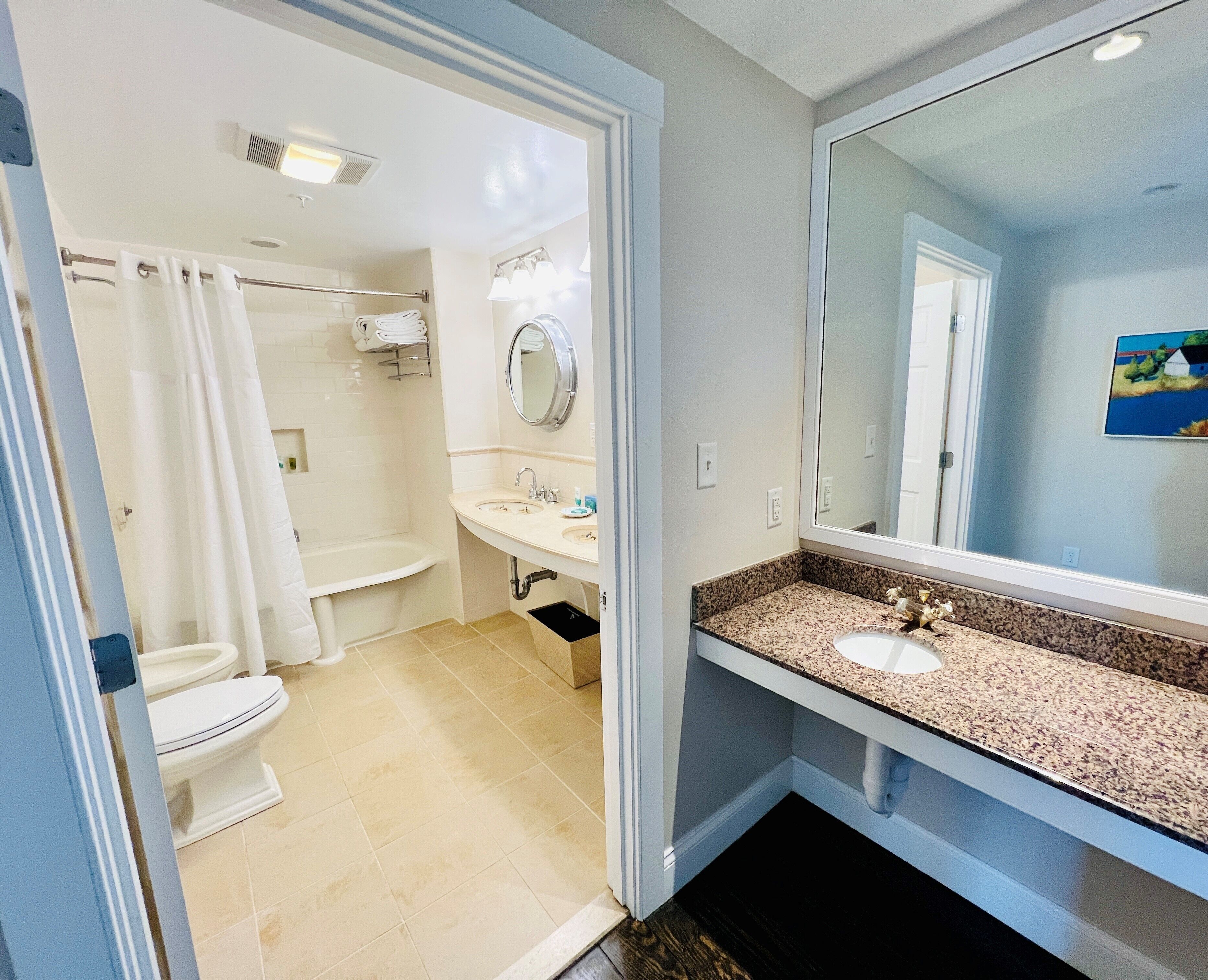 A bathroom with a toilet, sink, and shower.