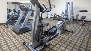 A gym with various exercise machines including treadmills, elliptical trainers, and weight machines. - Baymont by Wyndham Hays (Hays)