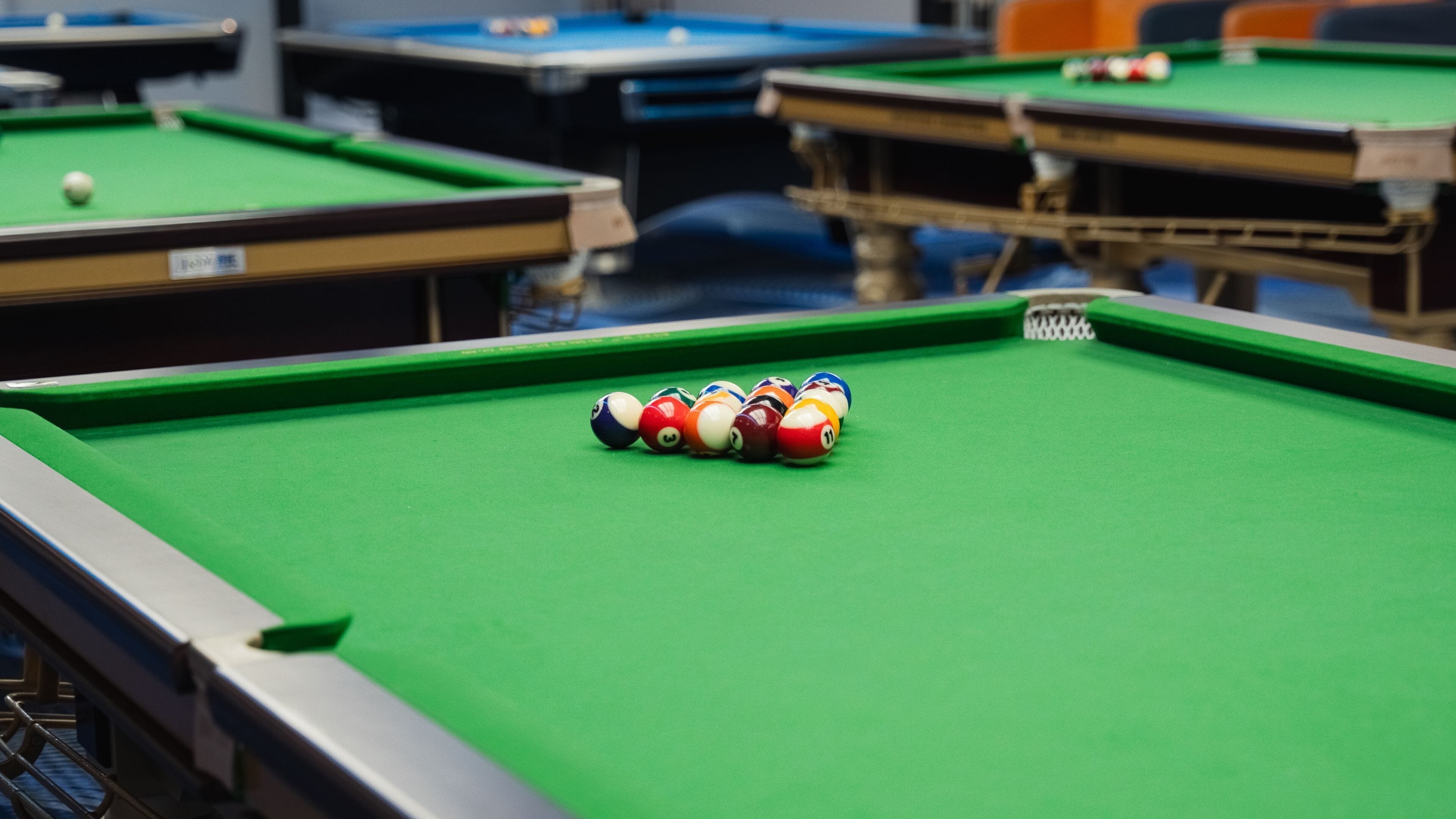 A pool table with a set of billiard balls.