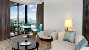 A hotel room with a large window, a sofa, a coffee table, and a lamp. - Crowne Plaza Toronto North York by IHG (Toronto)