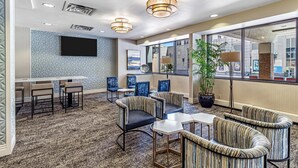 A hotel lobby with a bar, seating area, and large windows. - DoubleTree by Hilton Milwaukee Downtown (Milwaukee)