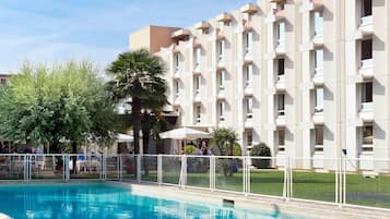 Outdoor pool, open 9:00 AM to 10:00 PM, pool umbrellas, pool loungers