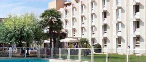 Outdoor pool, open 9:00 AM to 10:00 PM, pool umbrellas, pool loungers