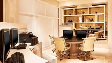 A modern office with two desks, computers, and chairs.