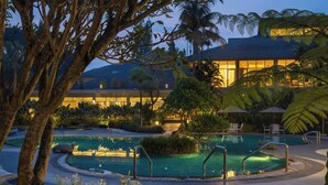 A pool area with a circular design, surrounded by tropical plants and palm trees. - Sheraton Bandung Hotel & Towers (Bandung)
