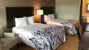 A hotel room with two beds, a nightstand, a lamp, and a chair. - Red Roof Inn Somerset, PA (Somerset)