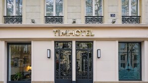 A hotel facade with a classic design, featuring a prominent "TIMHOTEL" sign above the entrance. - Timhotel Invalides Eiffel (Paris)