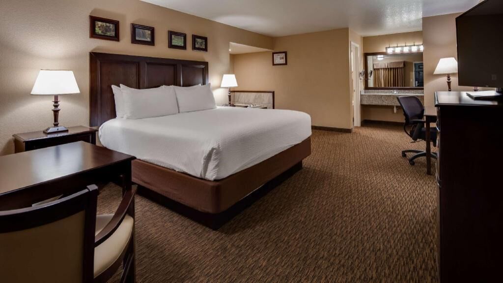 Premium bedding, desk, laptop workspace, blackout drapes