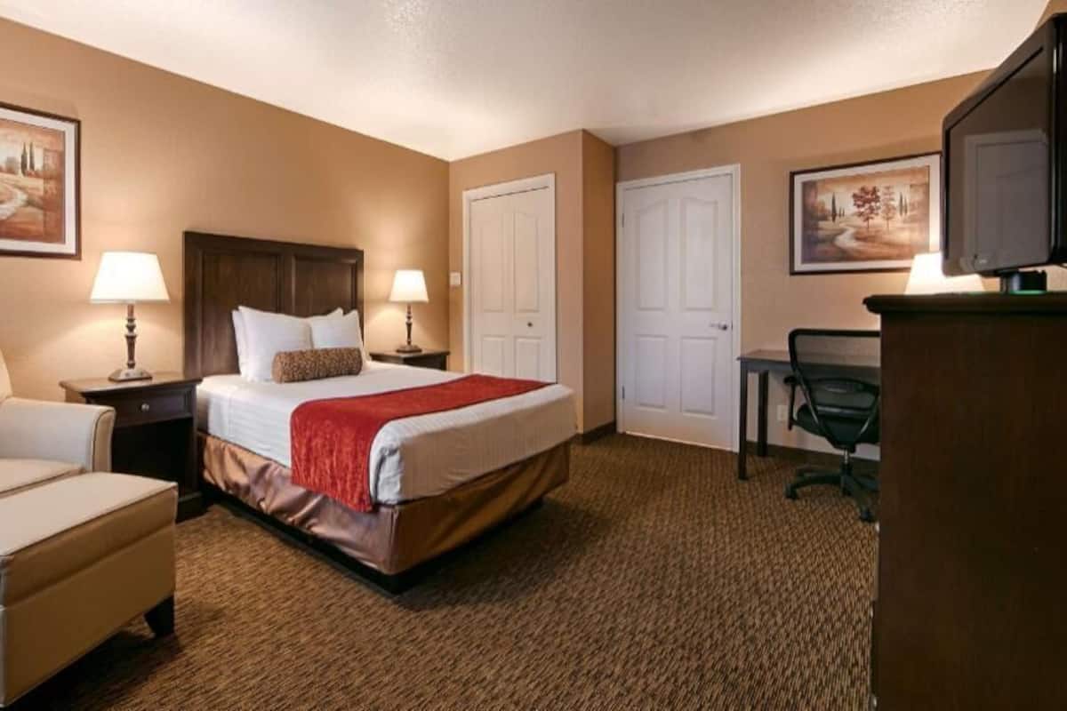 Premium bedding, desk, laptop workspace, blackout drapes