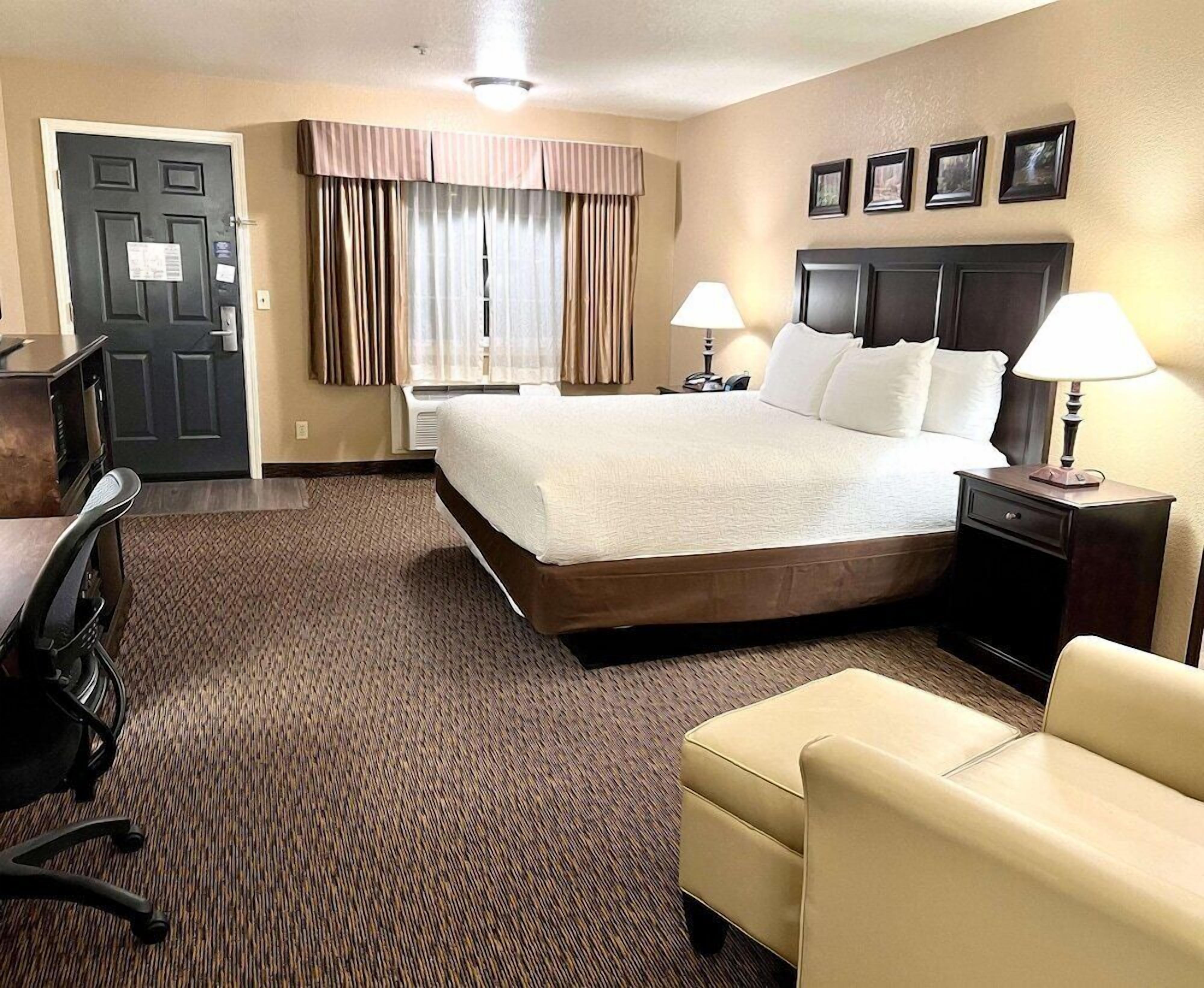 Premium bedding, desk, laptop workspace, blackout drapes