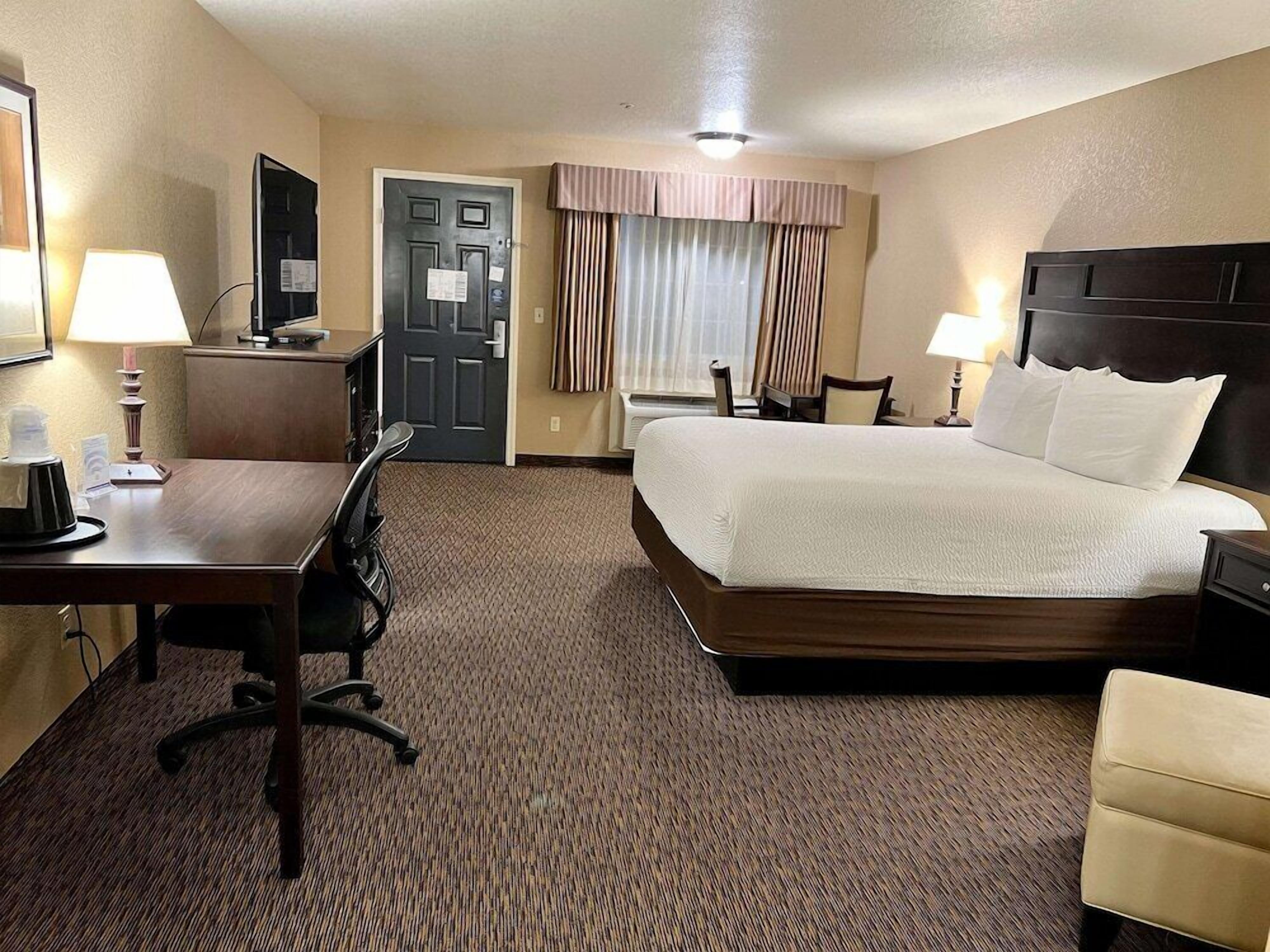 Premium bedding, desk, laptop workspace, blackout drapes