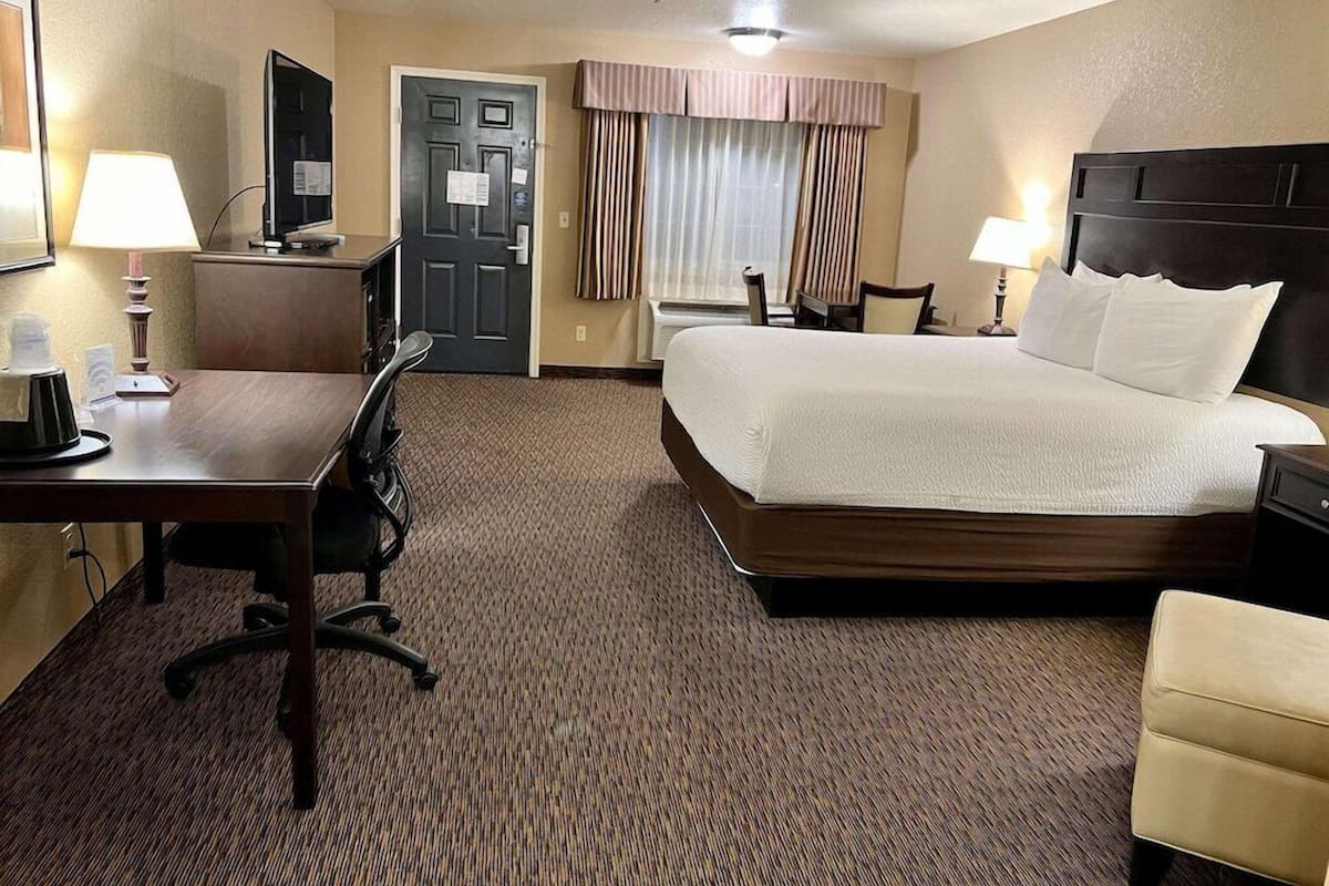 Premium bedding, desk, laptop workspace, blackout drapes