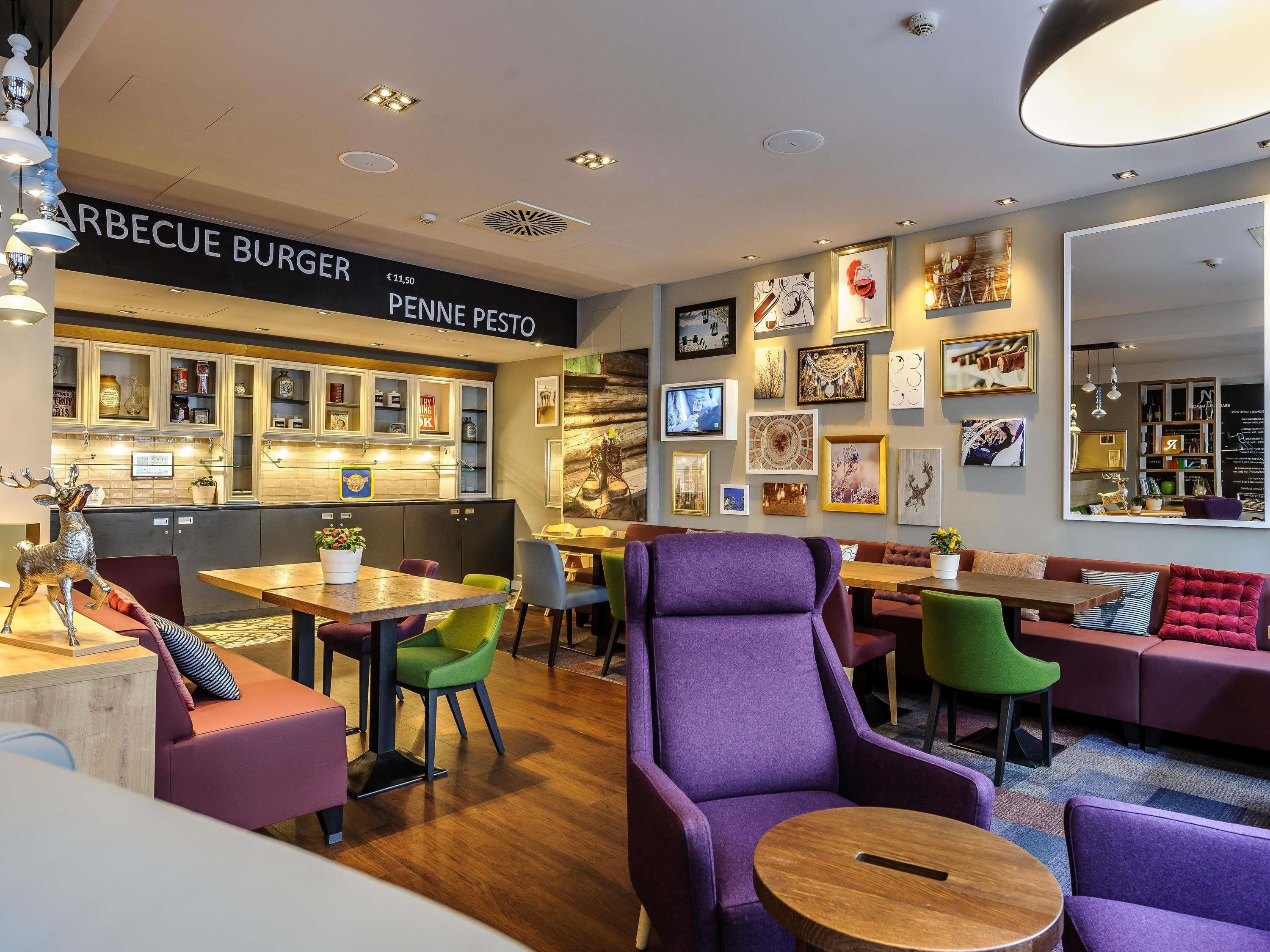 A restaurant interior with a bar area, seating, and wall art.