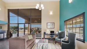 A modern living room with a sofa, armchairs, a coffee table, and a desk. - Best Western Conway (Conway)