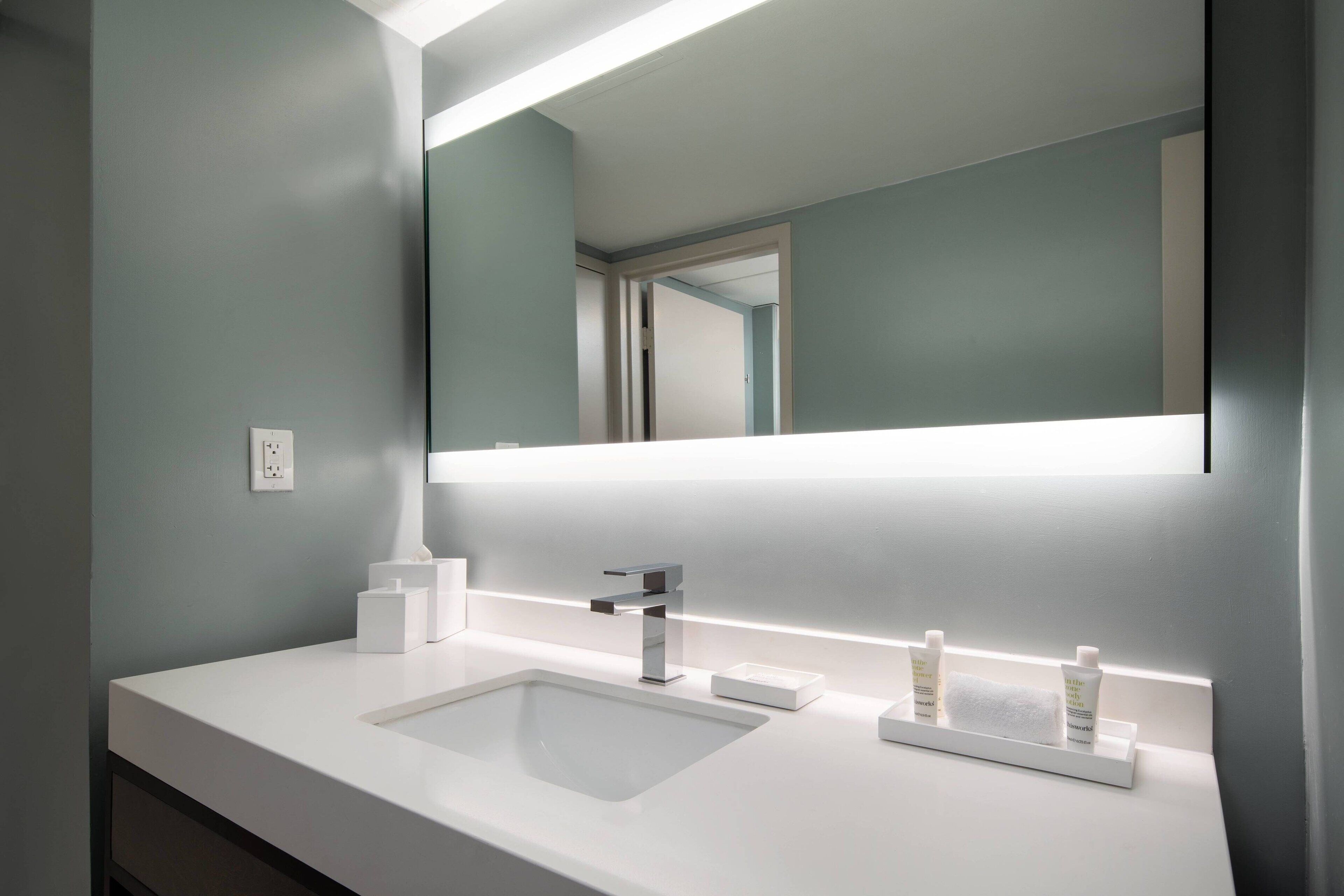 combined shower/bathtub, designer toiletries, hair dryer, towels