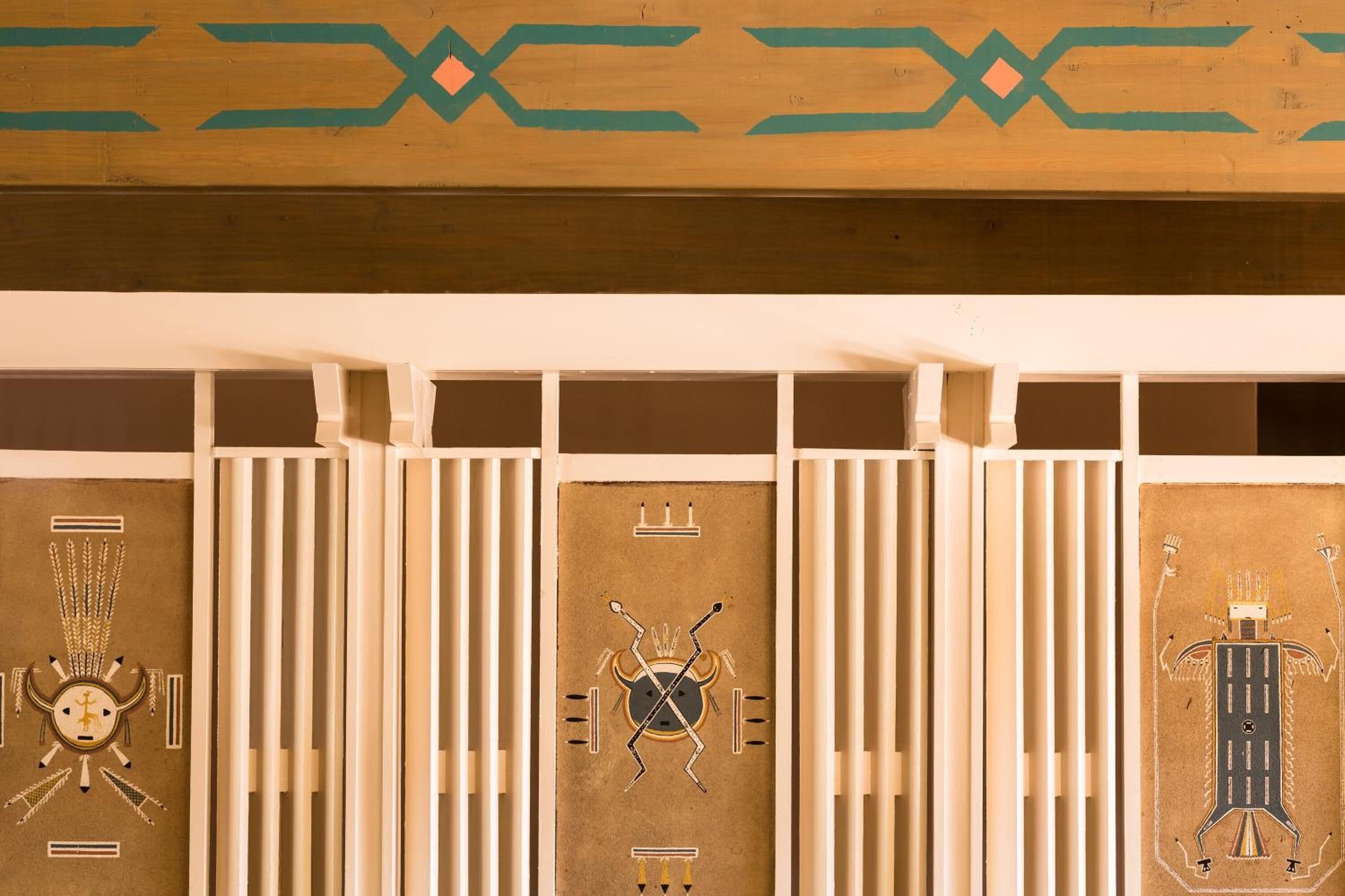 A series of panels with geometric and symbolic designs, possibly part of a decorative wall or paneling.