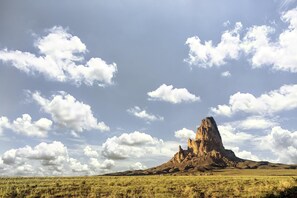 A natural landscape with a prominent rock formation in the center.