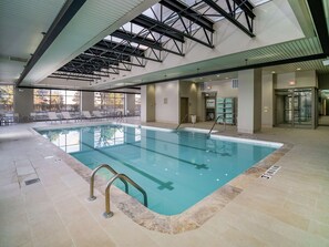 Relax by the large pool surrounded by a tiled floor and lounge chairs.