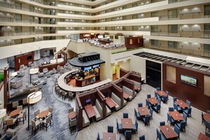 Relax in the spacious lobby with seating areas, a bar, and a large screen TV.