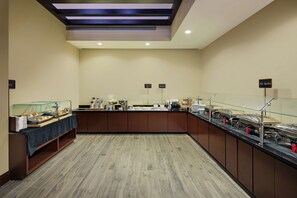 Enjoy a diverse spread at our buffet with various stations offering fresh fruit, hot dishes, and sweet pastries.