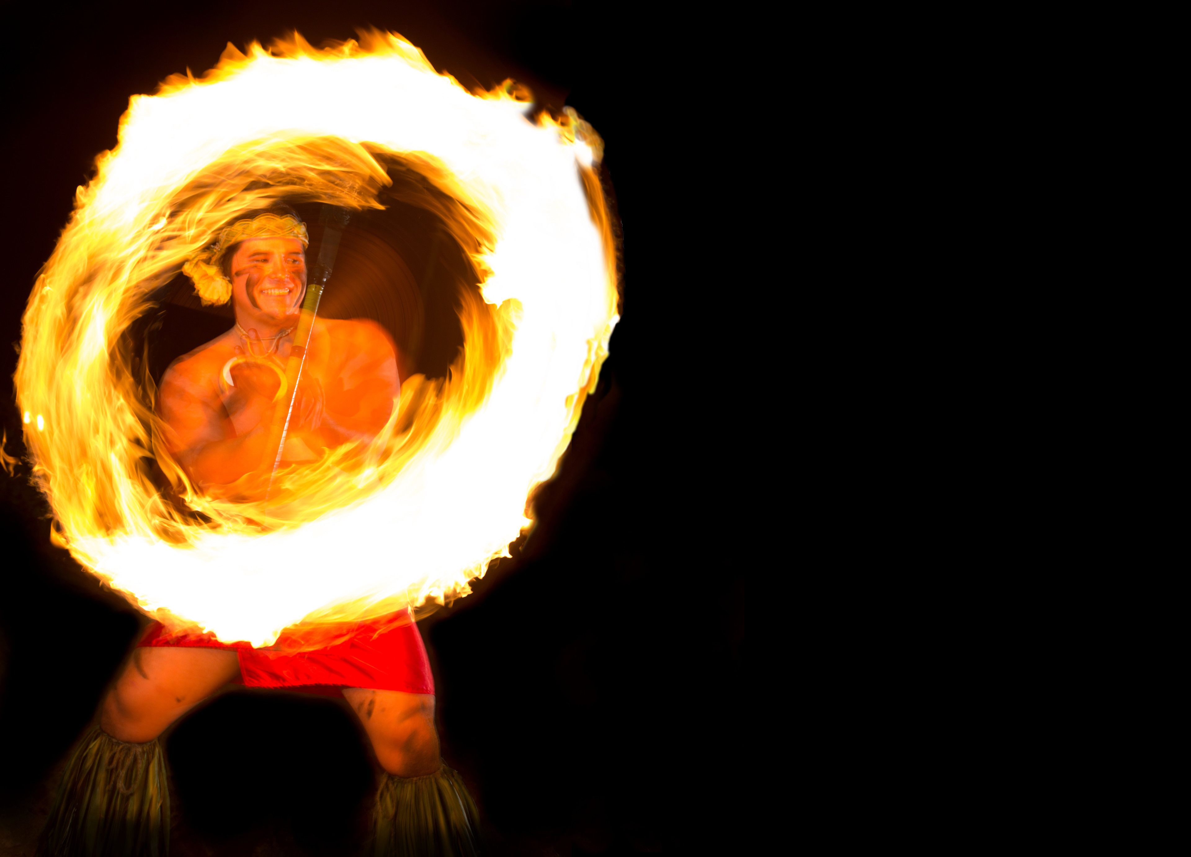 A performer with a fire hoop.