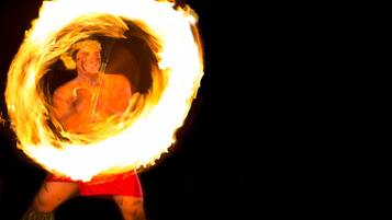 A performer with a fire hoop.
