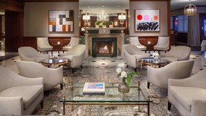 A spacious lobby with a fireplace, comfortable seating, and modern decor.