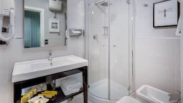 A modern bathroom with a glass-enclosed shower, a white sink, and a bathtub.
