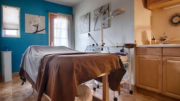 Cozy retreat with a comfortable bed, desk, and artwork adorning the walls.