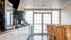 A kitchen with white cabinets, a wooden countertop, and a view to the outside. - Comfort Inn Lakeside (Mackinaw City)