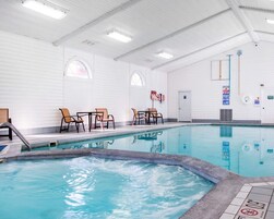 Una piscina techada, sillones reclinables de piscina