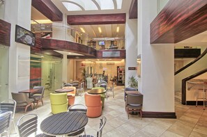 A multi-level indoor space with dining areas, a staircase, and a view of the lower level. - Balmoral Hotel San José CR, Historic District (San José)