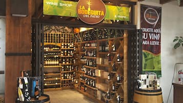 A wine shop interior with wooden shelves and a variety of wine bottles.