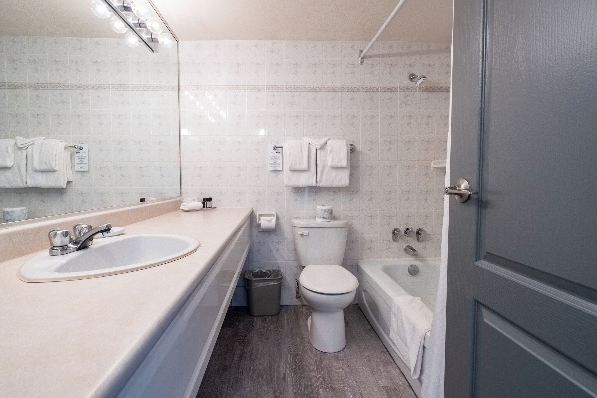 A modern bathroom with a sink, toilet, and bathtub.