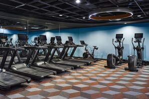 A gym with multiple treadmills, stationary bikes, and elliptical machines. - the Curtis Denver - a DoubleTree by Hilton Hotel (Denver)