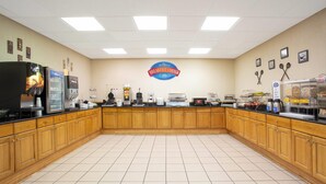 A breakfast area with wooden cabinets, a coffee machine, a toaster, and a sign reading "Breakfast Corner".