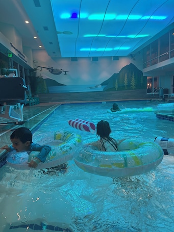 Una piscina techada, sillones reclinables de piscina