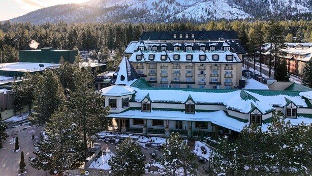 A large, multi-story hotel with a traditional architectural style, featuring a prominent central building with a green roof and multiple windows. - Margaritaville Resort Lake Tahoe (South Lake Tahoe)