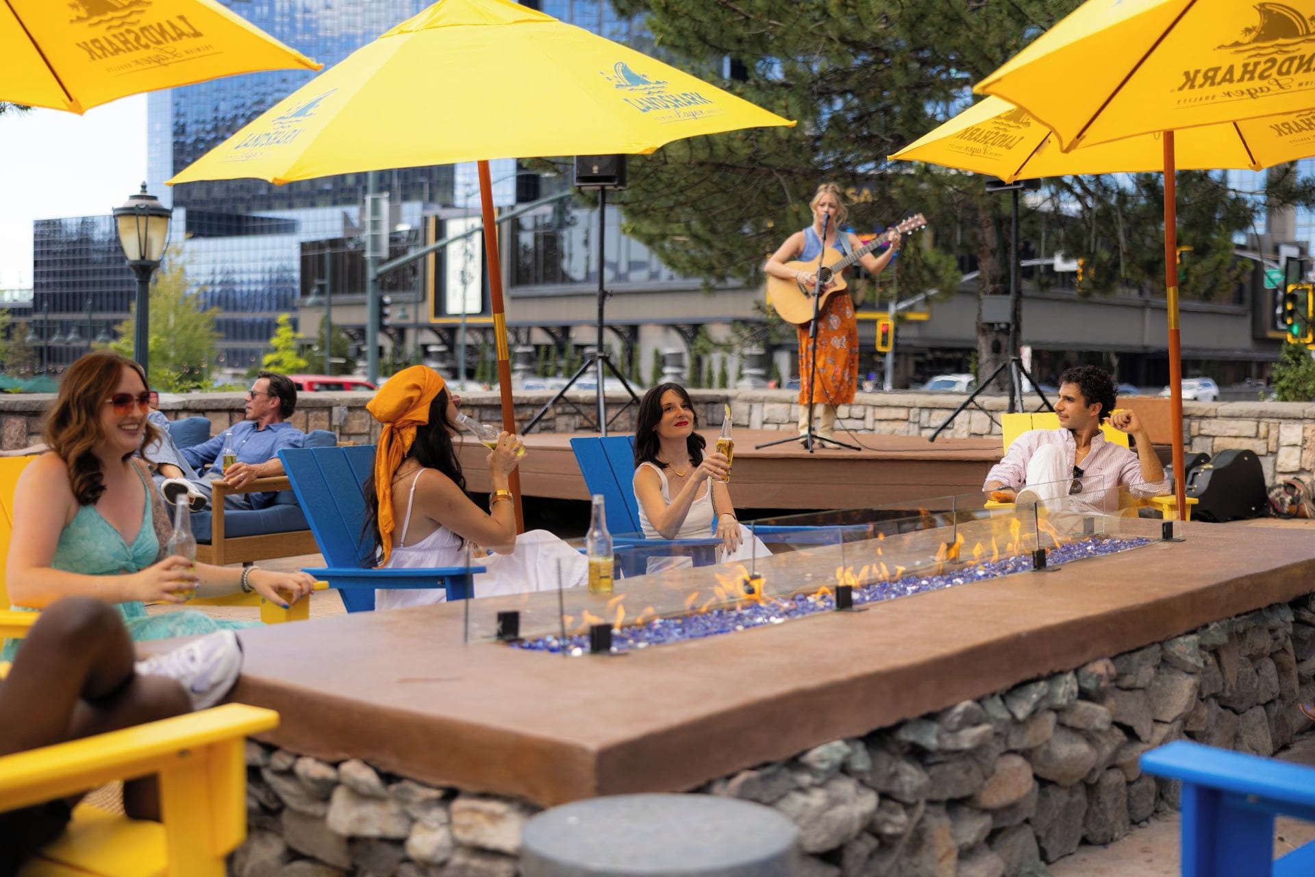 A bar area with outdoor seating and a stage for live music.