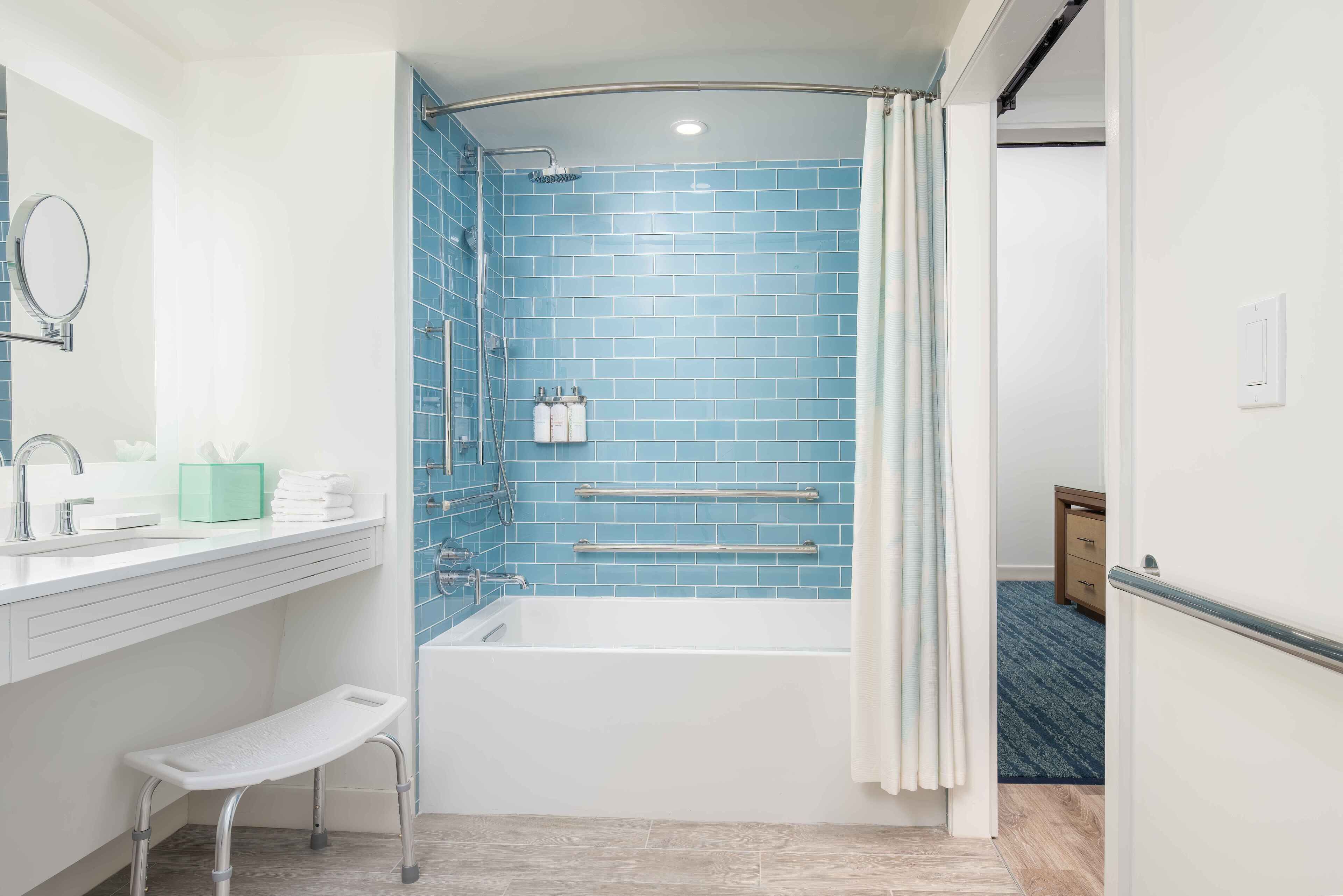 A bathroom with a bathtub, a shower, a toilet, and a sink.