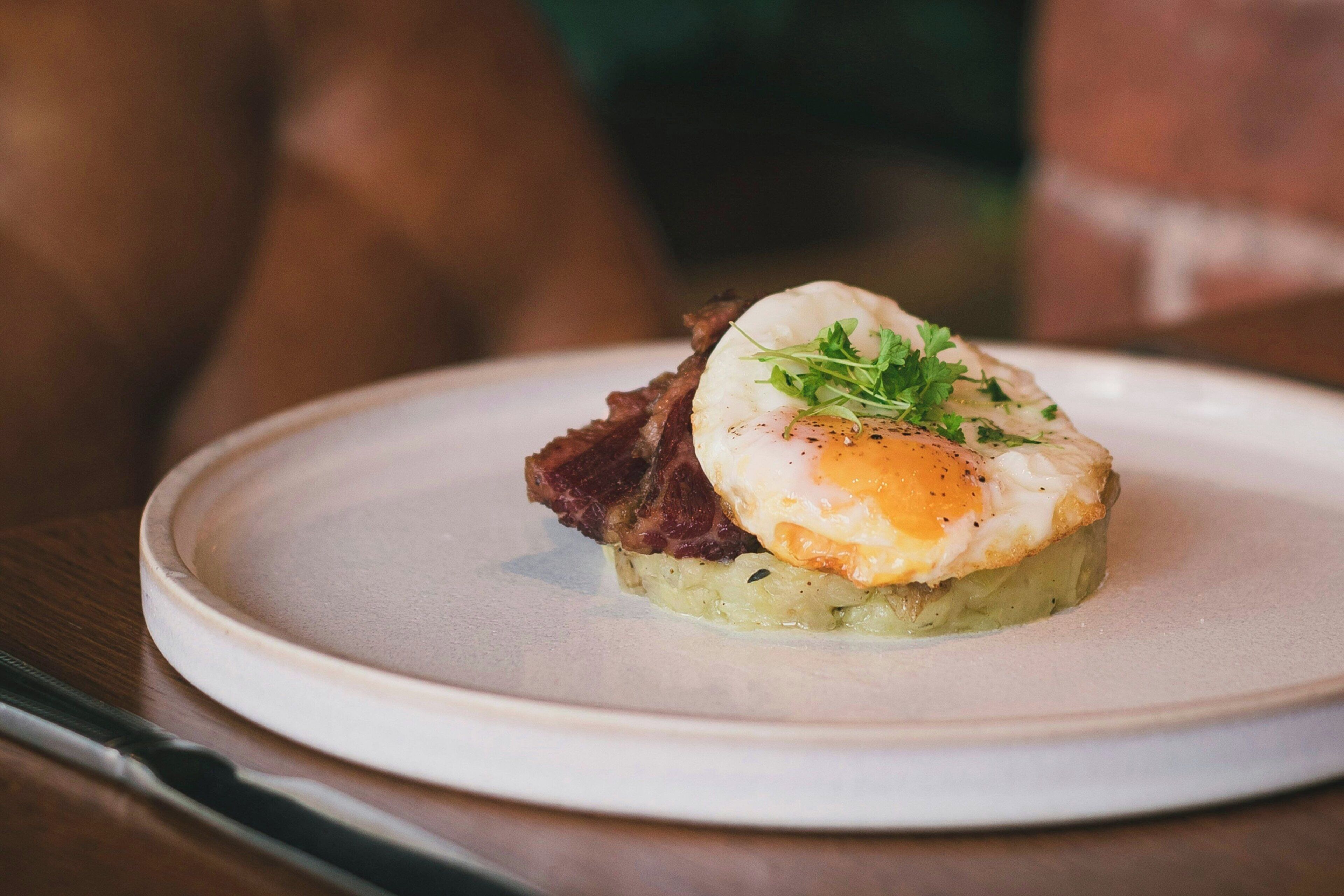 A plate with a food item, possibly a breakfast dish, on a white plate.