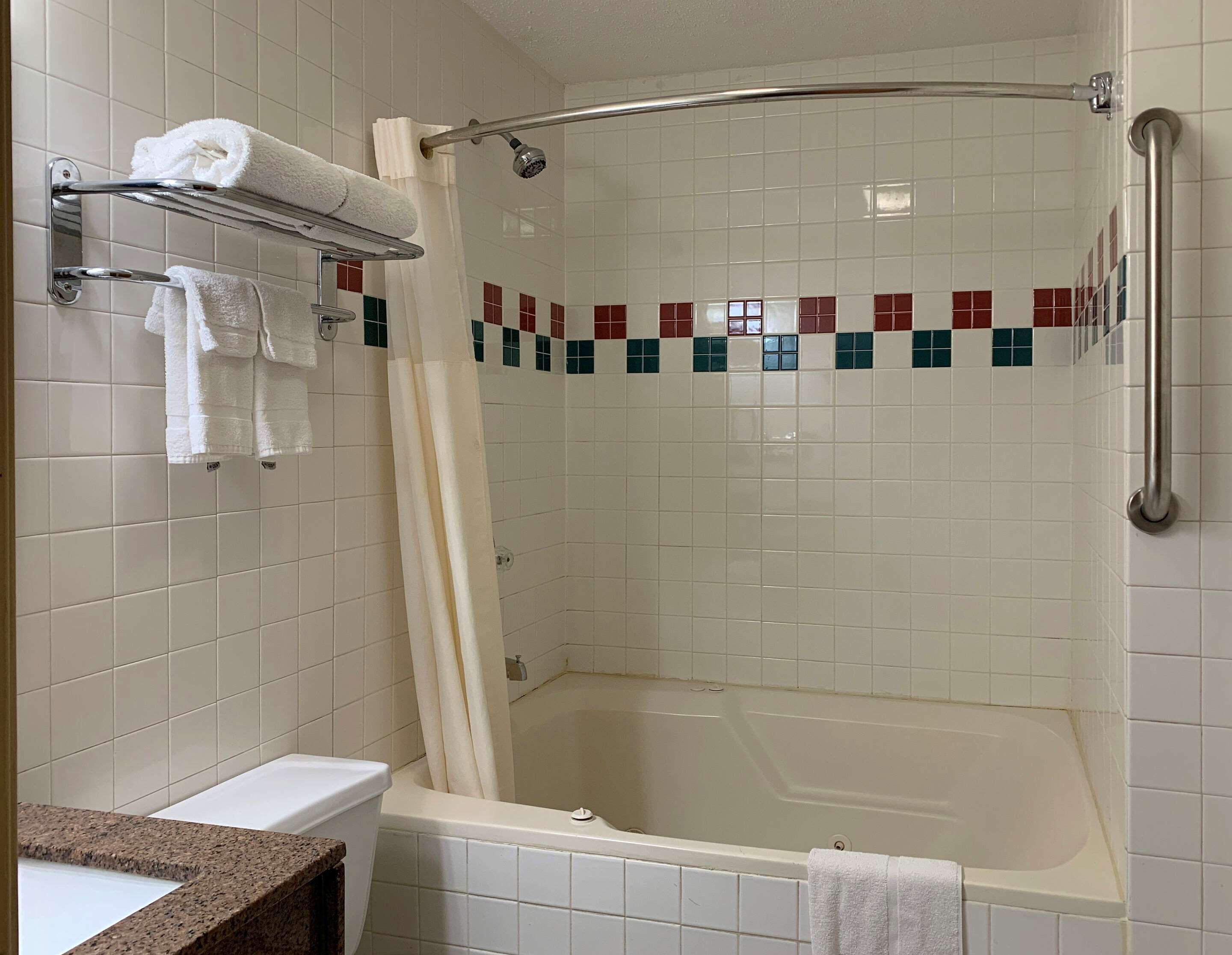 A bathroom with a shower, a bathtub, and a sink.