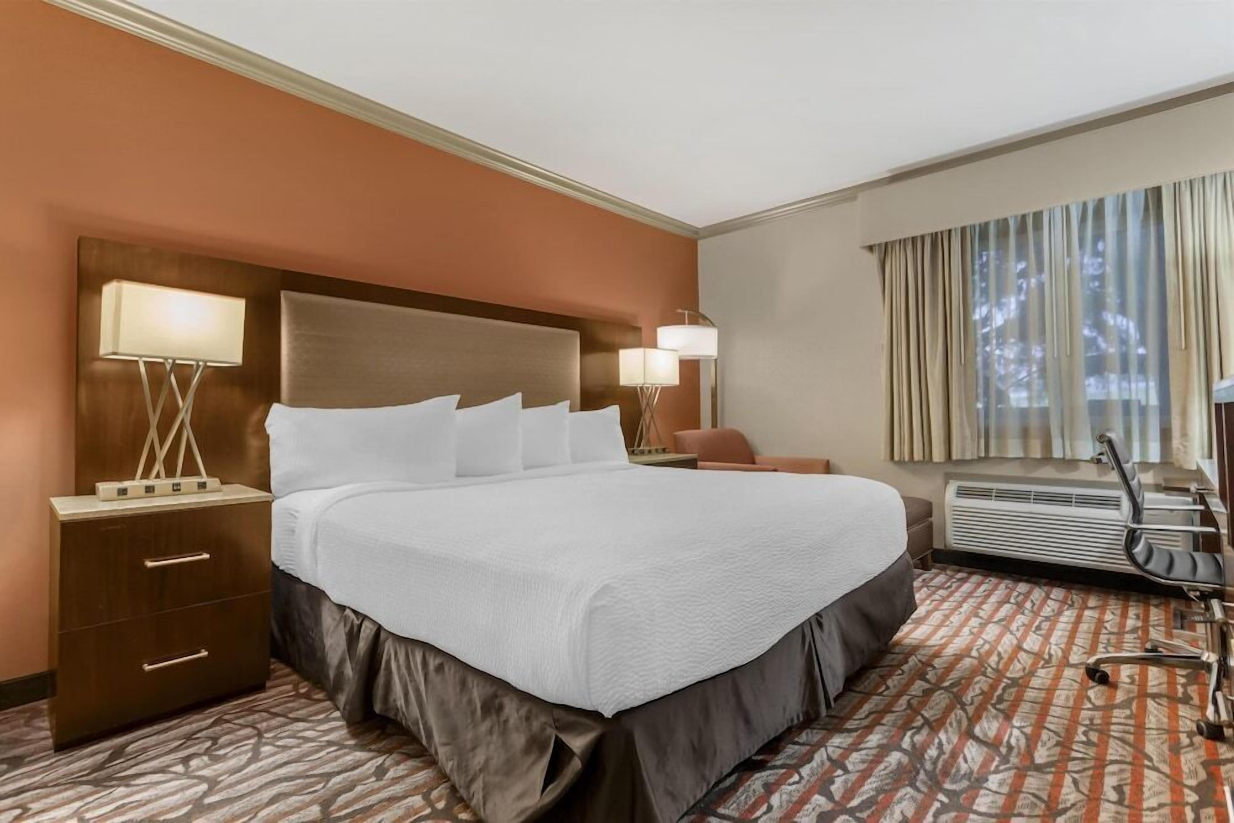 Premium bedding, desk, laptop workspace, iron/ironing board