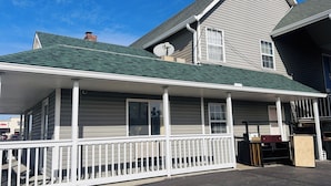 A two-story house with a covered porch and a satellite dish. - Residential Suites Blue Springs by Hotel O I 70 (Grain Valley)