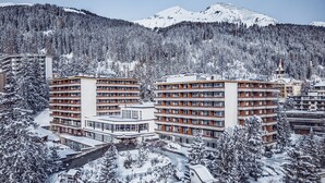 A hotel with multiple floors, a central courtyard, and snow-covered surroundings. - Mountain Plaza Hotel (Davos)